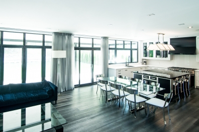 Designs by Santy :: Escarpment Modern Great room, dining and kitchen areas with ceiling-high windows