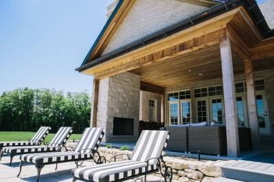Designs by Santy :: Hillside Estate Poolside porch with outdoor fireplace