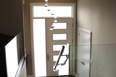Designs by Santy :: Saturn Transformation Foyer with glass railing and custom door