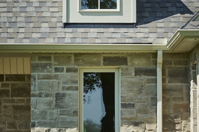 Designs by Santy :: French Country Revival Front exterior with curved dormer and stone