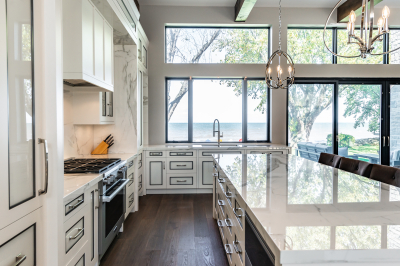 Designs by Santy :: Modern Lakehouse Kitchen with island, marble counter, large windows and lake view