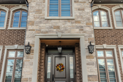 Designs by Santy :: Traditional Luxury Front exterior stone portico with keystone, sconces and front door