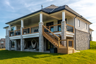 Designs by Santy :: Craftsman Bungalow Rear exterior covered deck and basement walk-out to patio with square stone columns